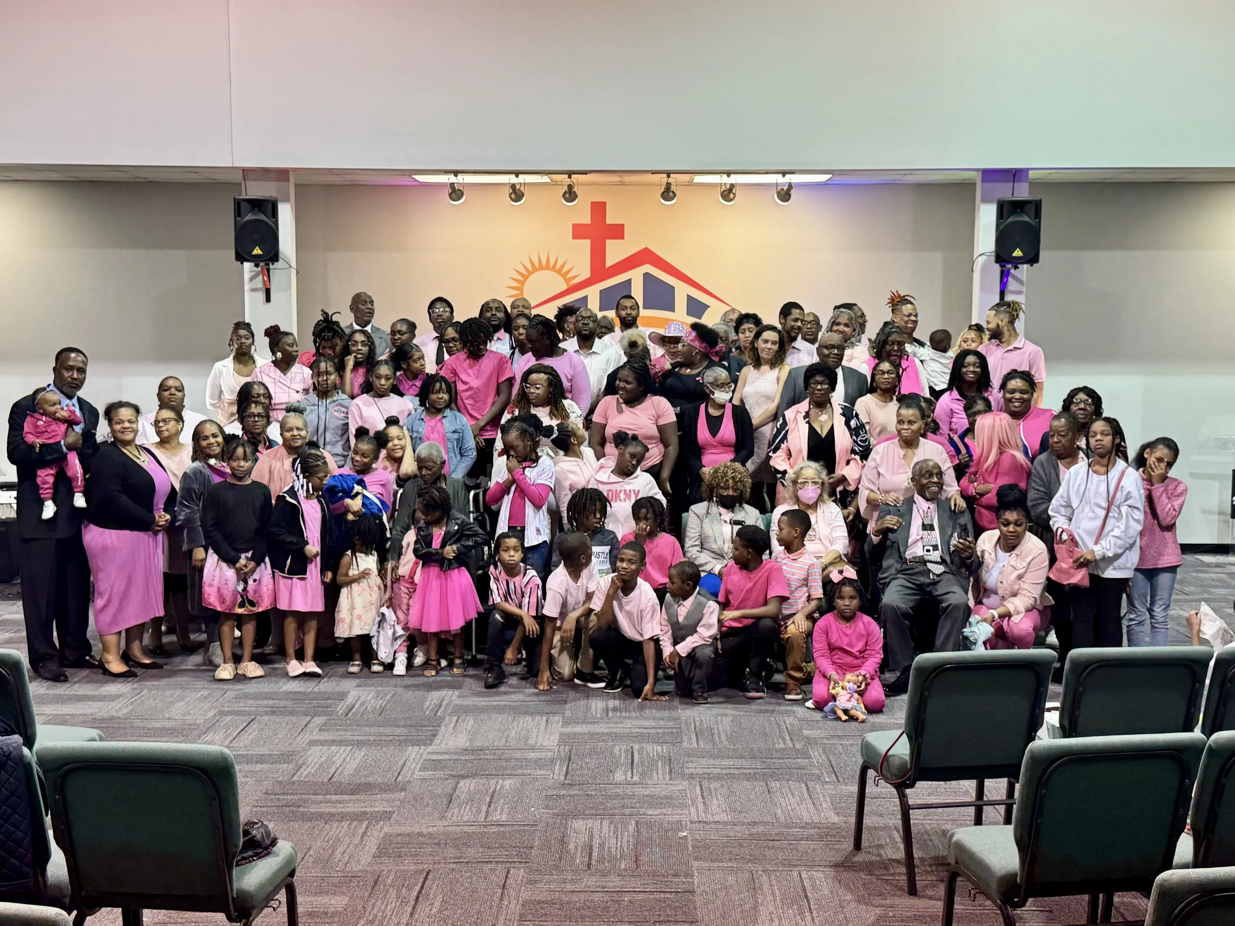 The church family gathered together, many dressed in pink