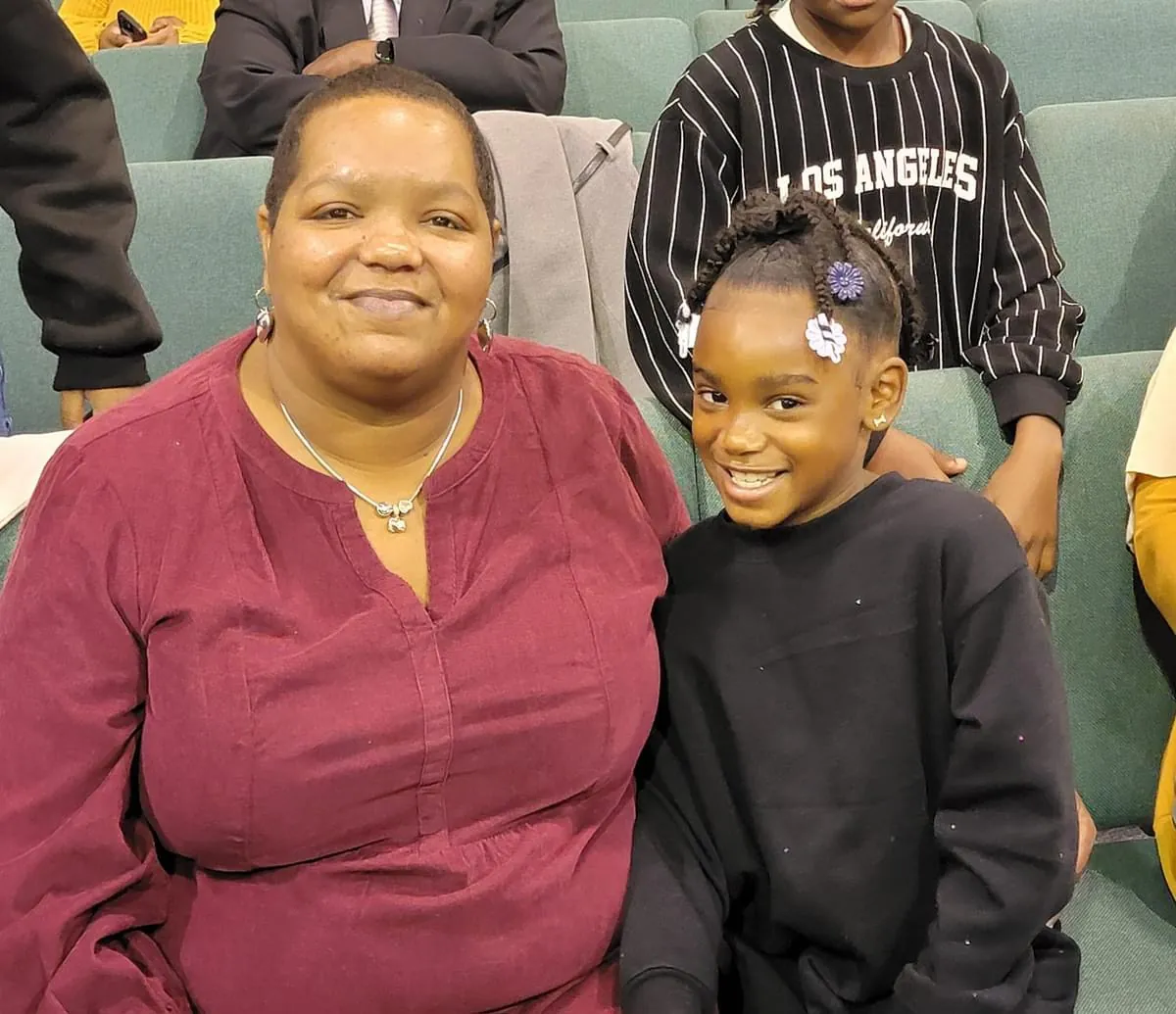 A mother and daughter smiling together at church