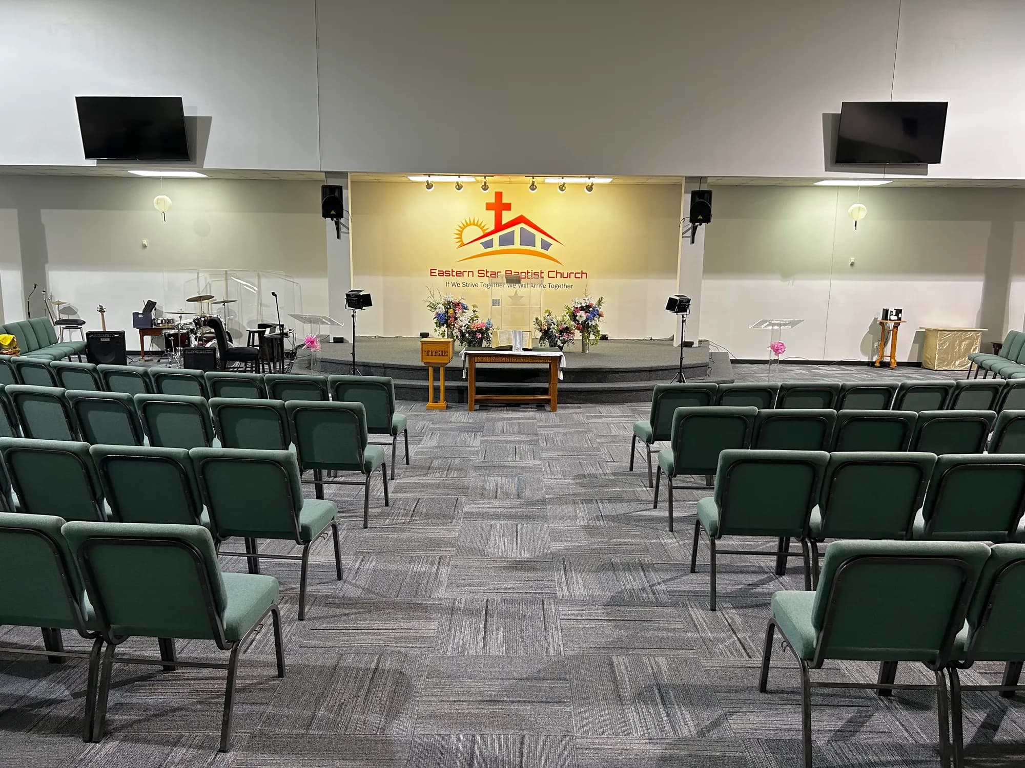 The Family Life Center sanctuary with the Eastern Star logo behind the stage