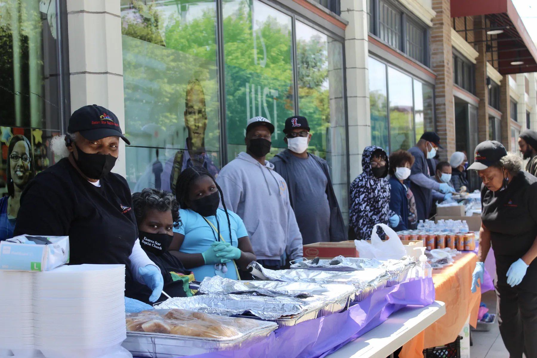 Volunteers serving food at an outdoor outreach